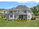 Back exterior showing backyard, screened porch, and patio seating area at 224 Hidden Meadows Dr, Mooresville, NC 28117
