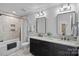 Well-lit bathroom with a shower, dual vanities, granite countertops, and modern fixtures at 224 Hidden Meadows Dr, Mooresville, NC 28117