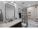 Stylish bathroom with a shower-tub combo, framed mirror, and playful shower curtain with a cartoon pattern at 224 Hidden Meadows Dr, Mooresville, NC 28117