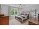 Comfortable bedroom with soft carpet, a large window with a view of trees, and neutral decor at 224 Hidden Meadows Dr, Mooresville, NC 28117