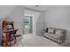 Bright and spacious bonus room featuring a vintage arcade game, a comfortable sofa, and neutral wall paint at 224 Hidden Meadows Dr, Mooresville, NC 28117