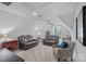 Expansive bonus room with dual reclining sofas, an accent chair, a ceiling fan, and neutral wall paint at 224 Hidden Meadows Dr, Mooresville, NC 28117
