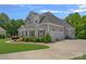 Side view of a beautiful two-story home with a three-car garage and well-maintained landscaping at 224 Hidden Meadows Dr, Mooresville, NC 28117