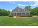 Charming two-story home with manicured lawn, decorative landscaping, and a welcoming entryway at 224 Hidden Meadows Dr, Mooresville, NC 28117