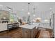 Kitchen with island and bar seating with a clear view to the living room and fireplace at 224 Hidden Meadows Dr, Mooresville, NC 28117