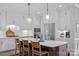 Bright kitchen featuring custom white cabinets, subway tile backsplash, and a large center island at 224 Hidden Meadows Dr, Mooresville, NC 28117