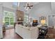Open living room with stone fireplace, vaulted ceiling, and many windows for natural light at 224 Hidden Meadows Dr, Mooresville, NC 28117