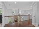 Open loft area overlooking the living room, with views of the fireplace and backyard at 224 Hidden Meadows Dr, Mooresville, NC 28117