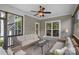 Cozy screened-in porch with comfortable seating, ceiling fan, and serene outdoor views at 224 Hidden Meadows Dr, Mooresville, NC 28117