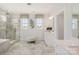 Relax in this modern bathroom with a frameless shower and free-standing tub at 2529 Mabel Ln, Monroe, NC 28110