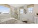Spa-like bathroom with marble tile, dual vanities, soaking tub, and a glass shower at 2529 Mabel Ln, Monroe, NC 28110
