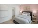 Charming bedroom featuring pink accent wall and minimalist decor at 2529 Mabel Ln, Monroe, NC 28110