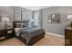 Comfortable bedroom featuring a soft gray palette, wood furniture, and natural light at 2529 Mabel Ln, Monroe, NC 28110