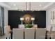 Formal dining room showcasing an elegant light fixture and decorative wall paneling at 2529 Mabel Ln, Monroe, NC 28110