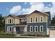 Two-story home featuring stone accents, beige and blue siding, multi-pane windows, and professionally landscaped yard at 2529 Mabel Ln, Monroe, NC 28110
