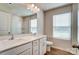 Well-lit bathroom with double sinks, white cabinetry, and a framed mirror above a white countertop at 2648 Tillman St, Monroe, NC 28112