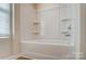 Bright bathroom features a white tub-shower combination with built-in shelving and modern chrome hardware at 2648 Tillman St, Monroe, NC 28112