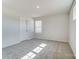 Bright bedroom with neutral carpet, white walls, ample natural light and a single door entrance at 2648 Tillman St, Monroe, NC 28112