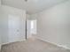 Neutral bedroom with carpet, with an open doorway to an adjacent room, and closet at 2648 Tillman St, Monroe, NC 28112