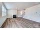 Bright living room featuring wood-look floors, a modern fireplace, and large windows at 2648 Tillman St, Monroe, NC 28112