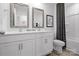Modern bathroom featuring dual sinks, white cabinets, and a shower-tub combo at 3064 Ora Smith Rd, Lincolnton, NC 28092
