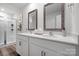 Bright bathroom featuring double sinks, white cabinetry, and a glass-enclosed shower at 3064 Ora Smith Rd, Lincolnton, NC 28092