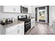 Well-lit kitchen with stainless steel oven and microwave, white cabinets, and granite countertops at 3064 Ora Smith Rd, Lincolnton, NC 28092