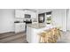 Modern kitchen features white cabinets, stainless steel appliances, granite counters, and a breakfast bar with seating at 3064 Ora Smith Rd, Lincolnton, NC 28092