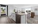 Kitchen island with a stainless steel dishwasher and sink, overlooking a bright living room and outdoor views at 3064 Ora Smith Rd, Lincolnton, NC 28092