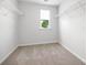 Spacious walk-in closet featuring wire shelving, window, and neutral carpet at 3064 Ora Smith Rd, Lincolnton, NC 28092