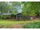 Exterior view of home with sunroom, complemented by beautiful landscaping and a well-maintained lawn at 3120 7Th Street Ne Dr, Hickory, NC 28601