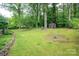 Expansive backyard with mature trees, storage shed, and lush lawn at 3120 7Th Street Ne Dr, Hickory, NC 28601