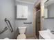 Bathroom featuring hand rails, tiled shower, tiled floors, a single sink, and a toilet at 3120 7Th Street Ne Dr, Hickory, NC 28601