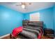 Bedroom with wood floors, blue wall, bed, a ceiling fan, and a dresser at 3120 7Th Street Ne Dr, Hickory, NC 28601
