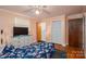 Comfortable bedroom with a floral comforter and a doorway to the bathroom at 3120 7Th Street Ne Dr, Hickory, NC 28601