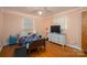Bedroom with wood floors, ceiling fan, hospital bed, dresser, and a peach colored wall at 3120 7Th Street Ne Dr, Hickory, NC 28601