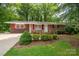 Charming brick home featuring a well-manicured front yard, tasteful landscaping, and a welcoming entrance at 3120 7Th Street Ne Dr, Hickory, NC 28601