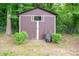 Outdoor storage shed with double doors nestled amongst mature landscaping and foliage at 3120 7Th Street Ne Dr, Hickory, NC 28601