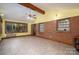 Open sunroom with tile flooring, a brick accent wall, and abundant natural light at 3120 7Th Street Ne Dr, Hickory, NC 28601