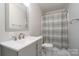 Updated bathroom features a modern vanity, neutral paint, and shower with stylish curtain at 321 Woodcrest Dr, York, SC 29745