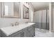 Bright bathroom with double sink vanity, gray cabinets and shower at 321 Woodcrest Dr, York, SC 29745