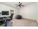 Versatile bedroom featuring plush carpet, a ceiling fan, and a brightly lit window at 321 Woodcrest Dr, York, SC 29745