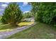 A serene setting of a cozy home tucked away among towering trees and lush greenery at 321 Woodcrest Dr, York, SC 29745