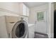 Bright laundry room with washer, dryer, and overhead storage at 321 Woodcrest Dr, York, SC 29745