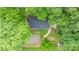 Aerial view of a home surrounded by lush green trees, yard, and storage shed at 352 18Th Ne Ave, Hickory, NC 28601