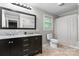 Bright bathroom featuring double vanity, tub/shower combo, toilet and a window at 352 18Th Ne Ave, Hickory, NC 28601