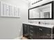 Bathroom featuring a double sink vanity with a framed mirror and natural light at 352 18Th Ne Ave, Hickory, NC 28601