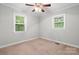 Well-lit bedroom with neutral walls and ceiling fan featuring two windows at 352 18Th Ne Ave, Hickory, NC 28601