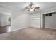 Cozy bedroom featuring neutral walls, ceiling fan, built-in shelves and closet at 352 18Th Ne Ave, Hickory, NC 28601