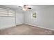Bedroom with neutral carpet, built-in shelving, and closet at 352 18Th Ne Ave, Hickory, NC 28601